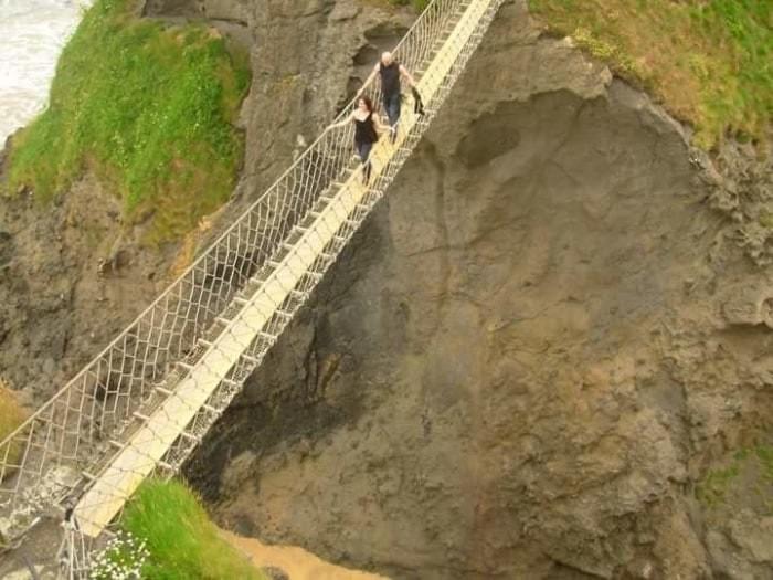 Walking across the Carrick rope bridge. 20 meters long and 30 meters high Walking across the Carrick rope bridge. 20 meters long and 30 meters high