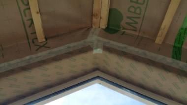 Timbertex airtight membrane meeting Isowindow F12 airtight window tape at apex of vaulted ceiling  