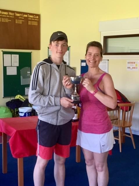 Pictured: Ryan Smith and Lynn McGarry, holding the Harold Birt Trophy. FHTTC Formby Holy Trinity Tennis Club Pictured: Ryan Smith and Lynn McGarry, holding the Harold Birt Trophy. FHTTC Formby Holy Trinity Tennis Club