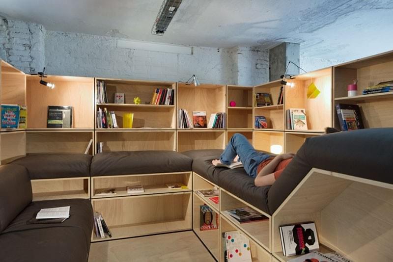 Designed by KINZO. Photography by Werner Huthmacher. Employee sleeping in wooden nap room Designed by KINZO. Photography by Werner Huthmacher. Employee sleeping in wooden nap room