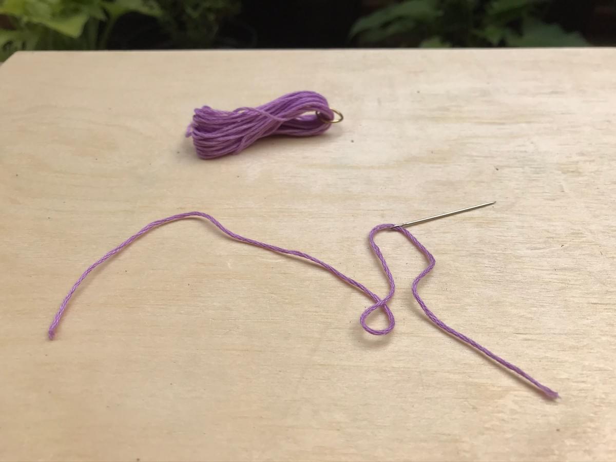 A short piece of thread, on a needle lay on the table A short piece of thread, on a needle lay on the table