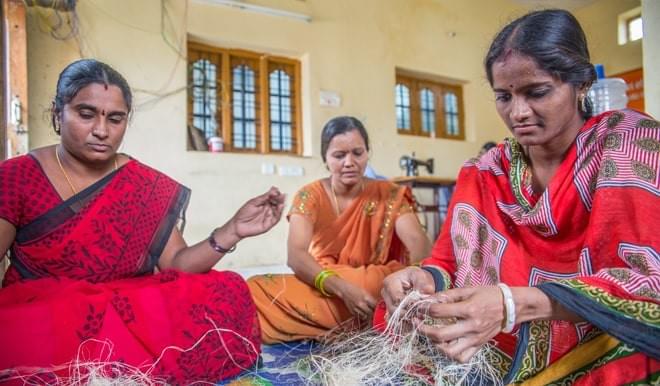 Women in India making reusable pads from banana fibre and cotton. Women in India making reusable pads from banana fibre and cotton.