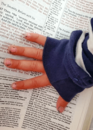 Baby Hand on Great Grandmother Bible Baby Hand on Great Grandmother Bible