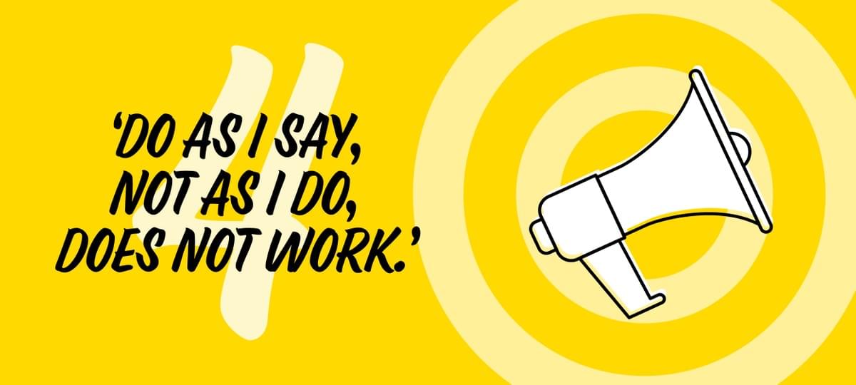 We Are Brass Tacks. internal communications. Employee engagement. HSE. HR. Workplace culture - White megaphone on yellow target background We Are Brass Tacks. internal communications. Employee engagement. HSE. HR. Workplace culture - White megaphone on yellow target background