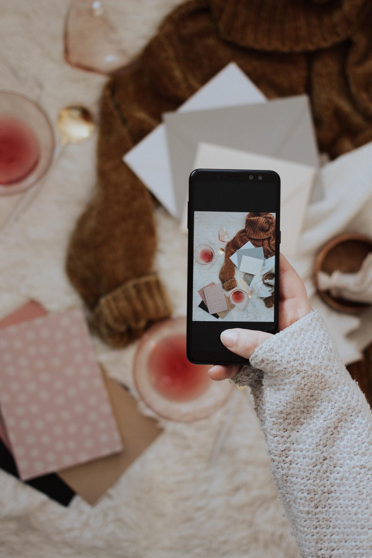 flat lay image by lilygraceimages stock photo of hand holding phone taking a picture flat lay image by lilygraceimages stock photo of hand holding phone taking a picture