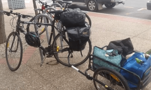 A bike with a trailer and pannier bags loaded with groceries A bike with a trailer and pannier bags loaded with groceries