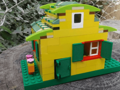 Lego sculpture of a green and yellow house Lego sculpture of a green and yellow house