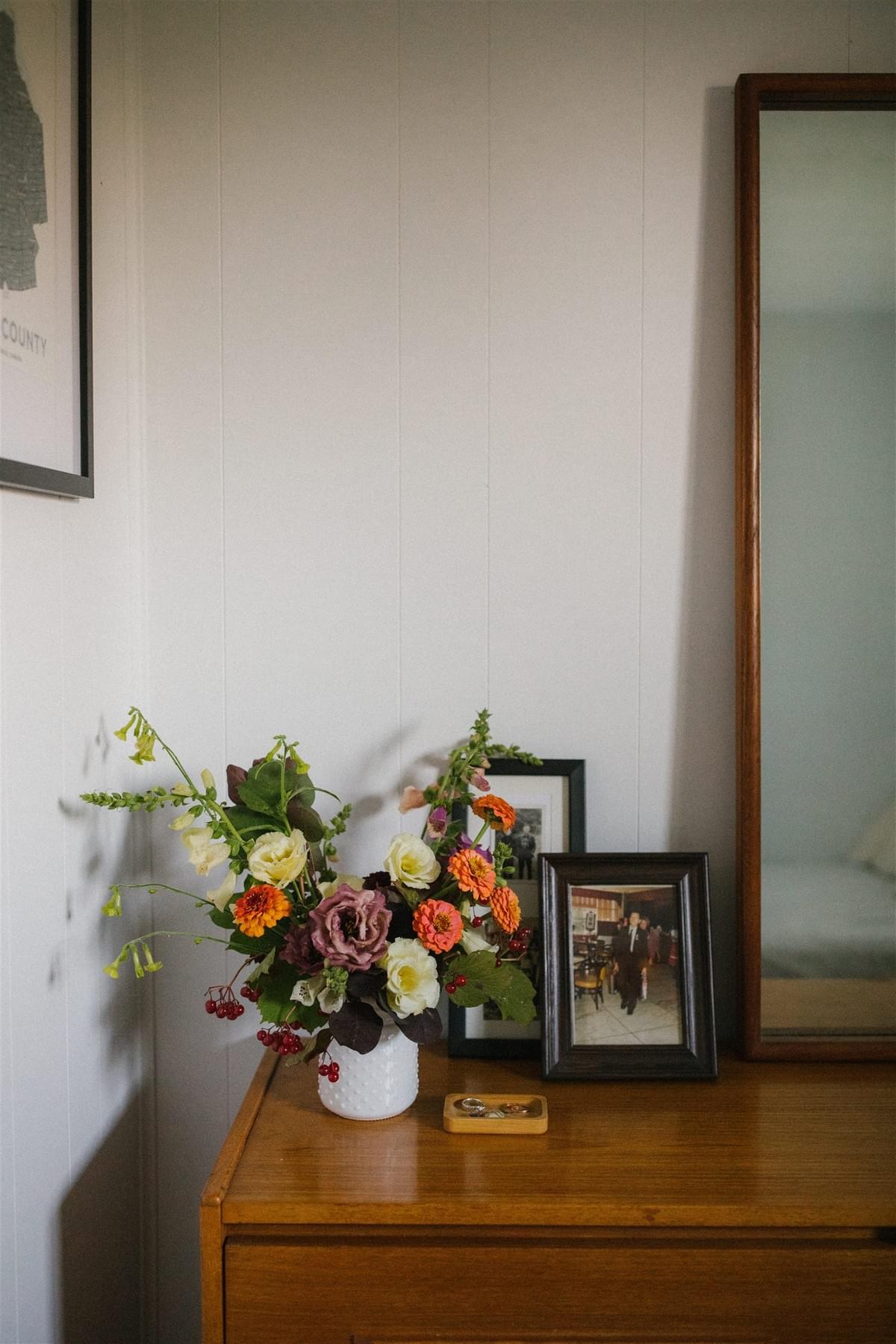 Statement floral arrangement on mid-century modern dresser in guest room Statement floral arrangement on mid-century modern dresser in guest room