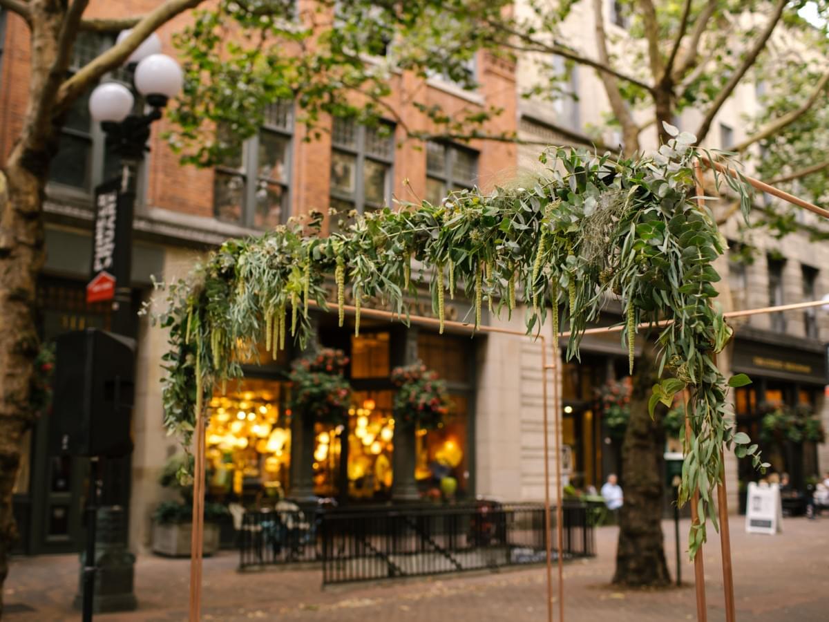 Copper chuppah with green garland for Jewish wedding ceremony in Pioneer Square, Seattle, Washington Copper chuppah with green garland for Jewish wedding ceremony in Pioneer Square, Seattle, Washington