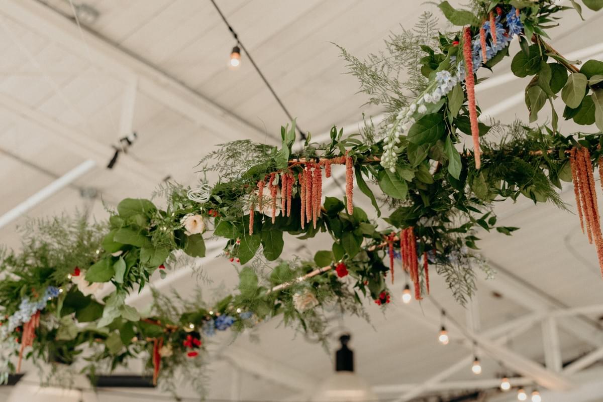 Lush hanging installation hung over the aisle and then over the wedding party's head table after the ceremony. Lush hanging installation hung over the aisle and then over the wedding party's head table after the ceremony.