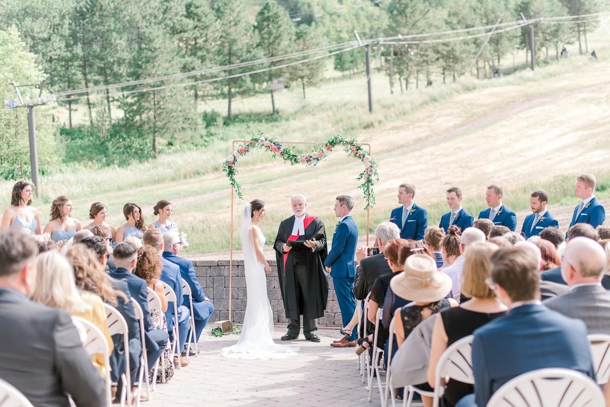 Floral garland on copper arch for airy, summer wedding ceremony at Craigleith Ski Club Floral garland on copper arch for airy, summer wedding ceremony at Craigleith Ski Club