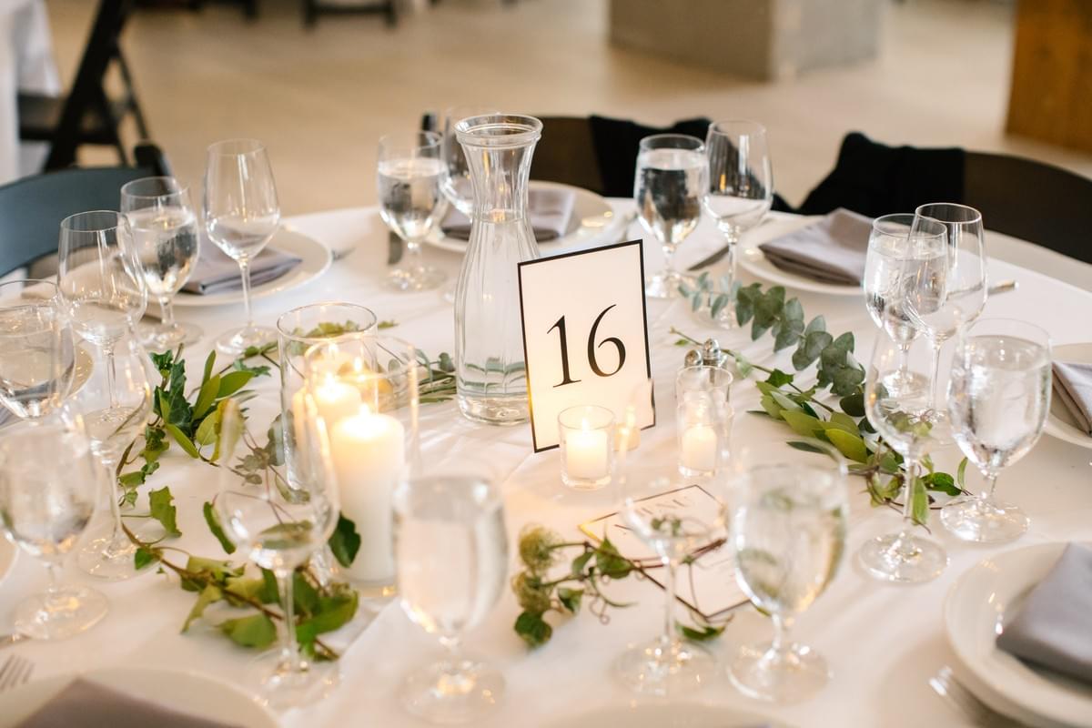 Pillar candle and foliage centerpiece for summer wedding at The 101 event venue in Seattle Pillar candle and foliage centerpiece for summer wedding at The 101 event venue in Seattle