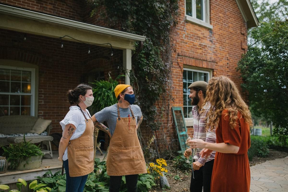 Hannah and Joel from Sumac and Salt greet dinner guests Andrew and Cassondra from Harvest Moon Farm outside the farmhouse. Hannah and Joel from Sumac and Salt greet dinner guests Andrew and Cassondra from Harvest Moon Farm outside the farmhouse.