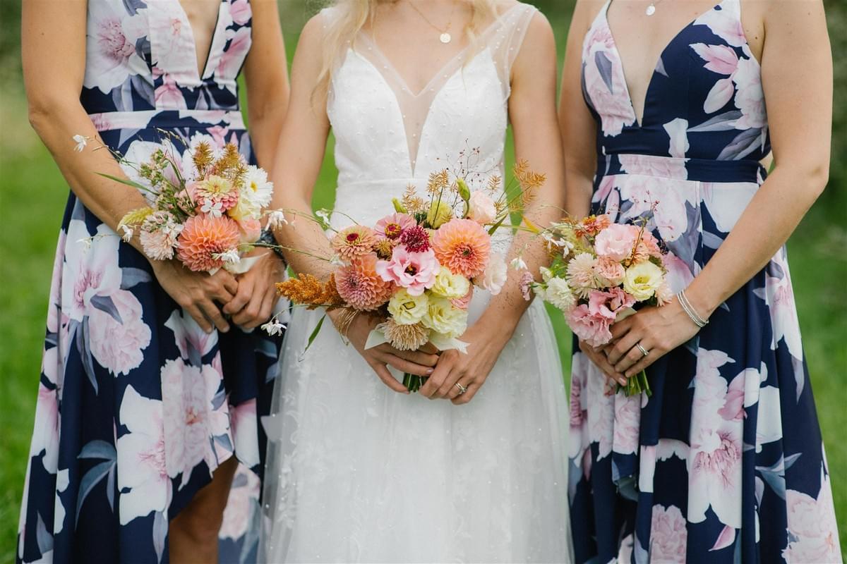 Peach and pink bridal and bridesmaid bouquets featuring local flowers at a barn wedding in Meaford, Ontario. Peach and pink bridal and bridesmaid bouquets featuring local flowers at a barn wedding in Meaford, Ontario.