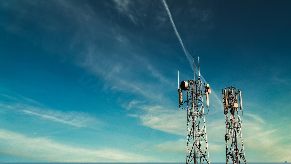 Two cell towers against blue sky Two cell towers against blue sky