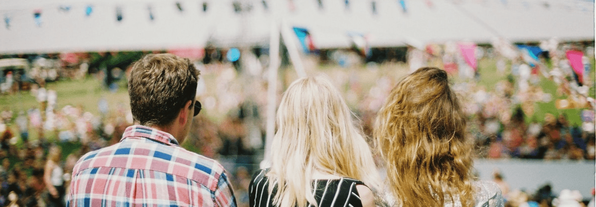 three people at a music festival in the lakes three people at a music festival in the lakes