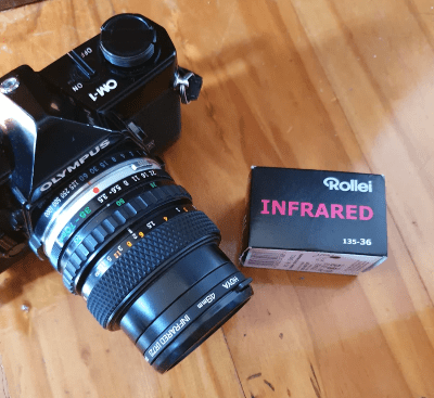 Olumpus OM1 camera and a box of 35mm Rollei Infrared film prior to loading it in the camera Olumpus OM1 camera and a box of 35mm Rollei Infrared film prior to loading it in the camera