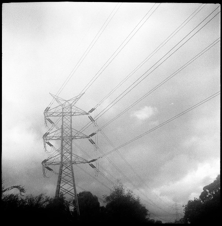 Looking up at large high voltage powerlines and dark grey clouds - test photography on a Voigtlander Brilliant Looking up at large high voltage powerlines and dark grey clouds - test photography on a Voigtlander Brilliant