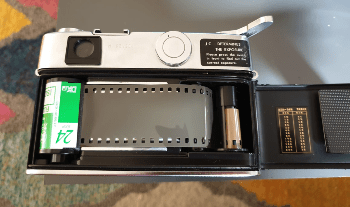 Yashica Ic Lynx 5000E camera from behind, showing a roll of Fuji Industrial film loaded, ready to close the back of the camera Yashica Ic Lynx 5000E camera from behind, showing a roll of Fuji Industrial film loaded, ready to close the back of the camera