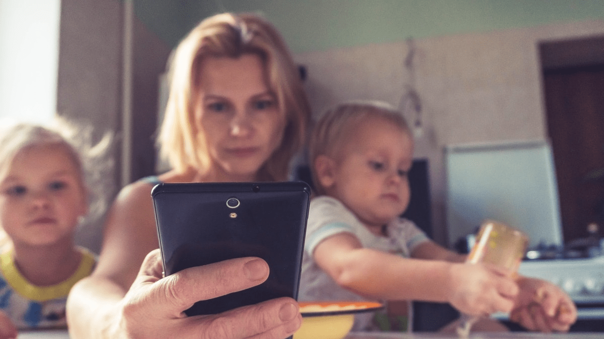 A woman working while taking care of children A woman working while taking care of children
