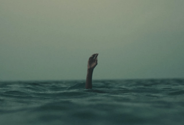 Image of a hand coming out of stormy water, which represents the feeling of being lost and alone Image of a hand coming out of stormy water, which represents the feeling of being lost and alone