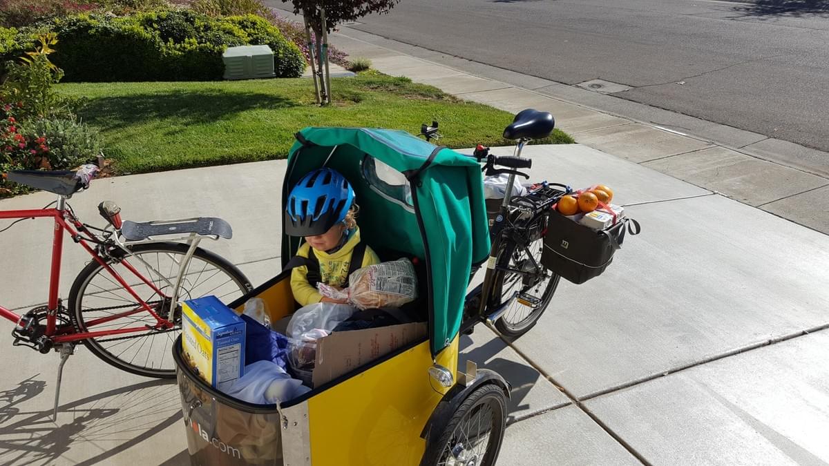 Nico and daughter pack up their Nihola Cargo Bike with groceries, ready to head home. Nico and daughter pack up their Nihola Cargo Bike with groceries, ready to head home.