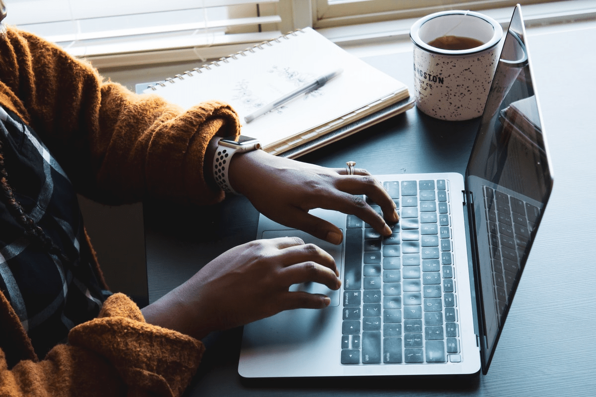 hands typing on a laptop hands typing on a laptop