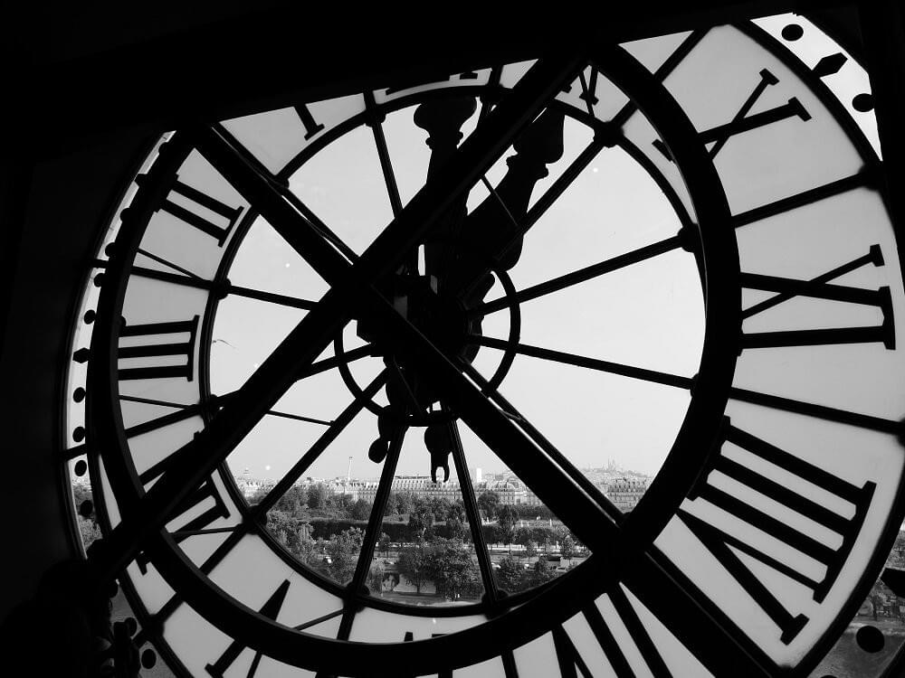 A pick from behind the face of a large clock on a tower is Paris, France as featured in The Purple Dog Blog post "Investing in Systems Will Set You Free" by The Purple Dog Vegan A pick from behind the face of a large clock on a tower is Paris, France as featured in The Purple Dog Blog post "Investing in Systems Will Set You Free" by The Purple Dog Vegan