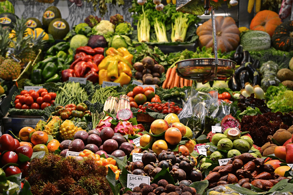A photo of a wide variety of fruits and vegetables at a shop or farmer's market. Photo featured in the blog post "7 Tips for Plant-Based Diet Beginners" in The Purple Dog Blog on The Purple Dog Vegan website. A photo of a wide variety of fruits and vegetables at a shop or farmer's market. Photo featured in the blog post "7 Tips for Plant-Based Diet Beginners" in The Purple Dog Blog on The Purple Dog Vegan website.