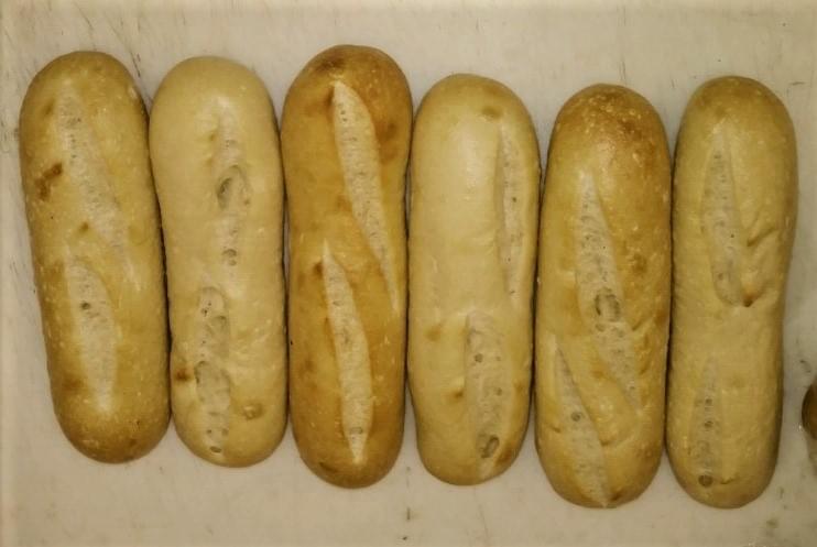 Raymond's Sourdough Mini Baguettes in their par baked state ready for oven browning. Raymond's Sourdough Mini Baguettes in their par baked state ready for oven browning.