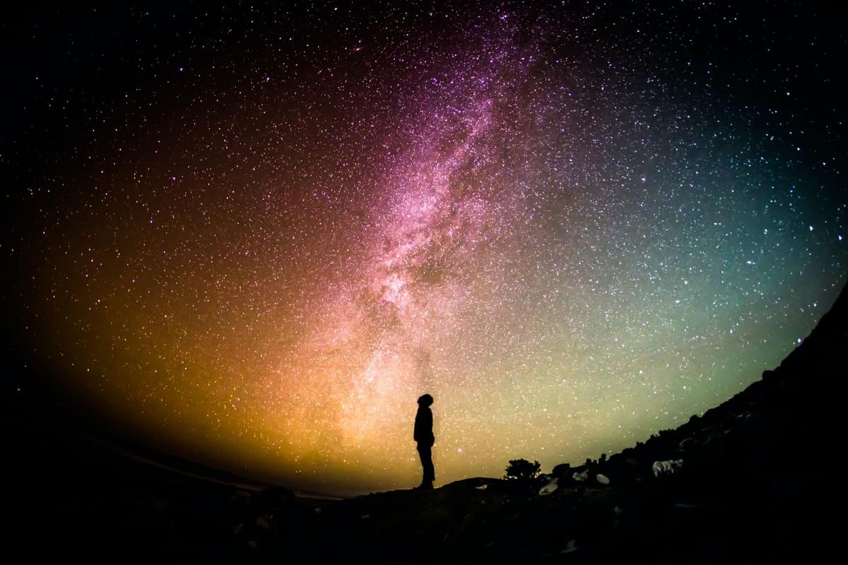 Image, courtesy of Greg Rakozy, of someone gazing upwards, silhouetted by the light of stars and especially by the Milky Way Image, courtesy of Greg Rakozy, of someone gazing upwards, silhouetted by the light of stars and especially by the Milky Way