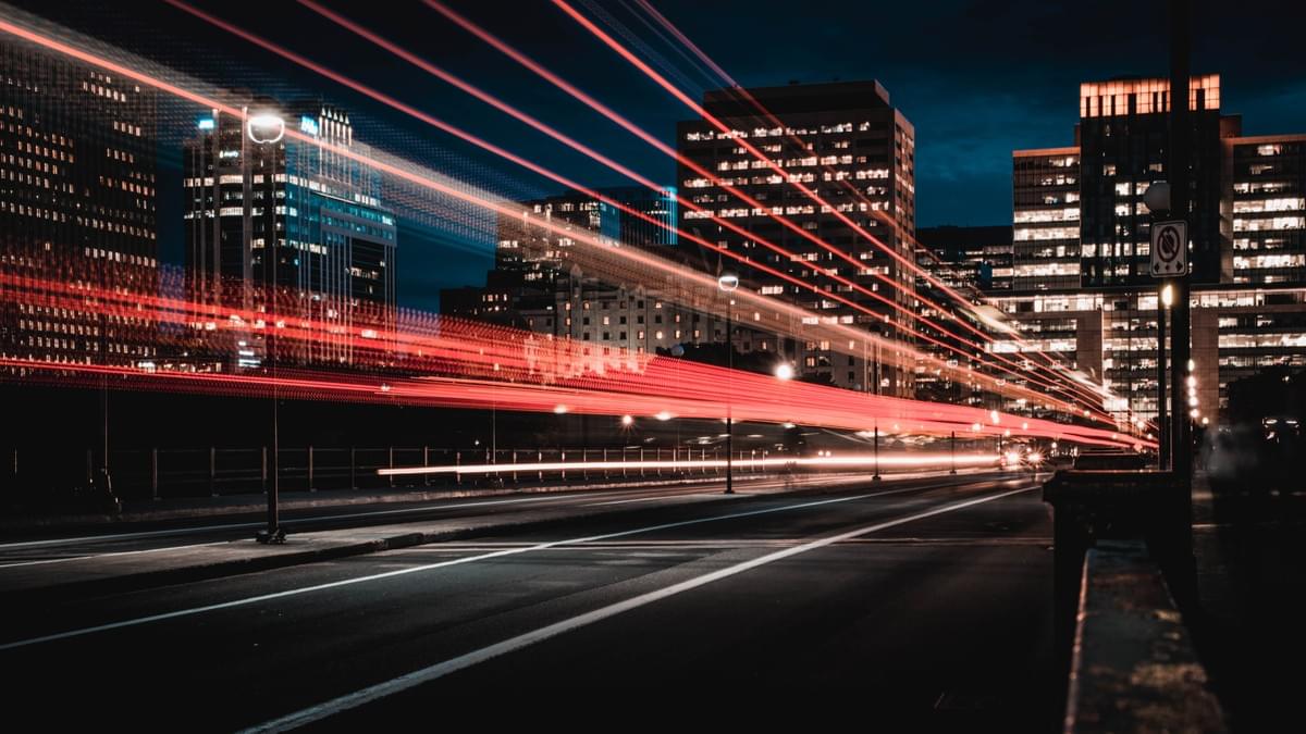 Image courtesy of Marc-Olivier Jordoin of a city scene at night with high rise buildings with brightly lit windows, and streams of red tail lights of the traffic. Image courtesy of Marc-Olivier Jordoin of a city scene at night with high rise buildings with brightly lit windows, and streams of red tail lights of the traffic.