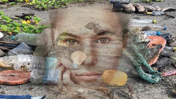 A girl’s face stares out from a litter-strewn beach. A girl’s face stares out from a litter-strewn beach.