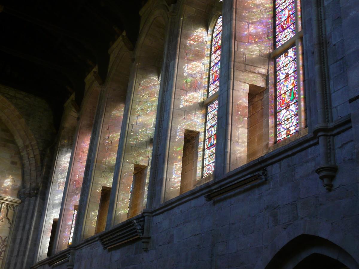 Image of the interior of an Anglican church that had originally been part of Bolton Abbey in North Yorkshire, England. It shows sunlight filtering through stained-glass windows, creating a kaleidoscope of aethereal colours. Image of the interior of an Anglican church that had originally been part of Bolton Abbey in North Yorkshire, England. It shows sunlight filtering through stained-glass windows, creating a kaleidoscope of aethereal colours.