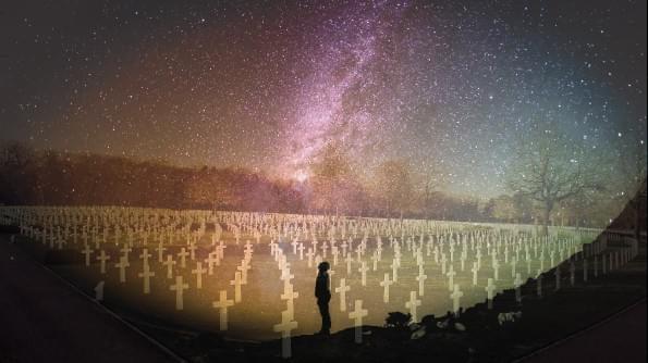 A figure is silhouetted against stars. The figure ponders a vast military cemetary. A figure is silhouetted against stars. The figure ponders a vast military cemetary.