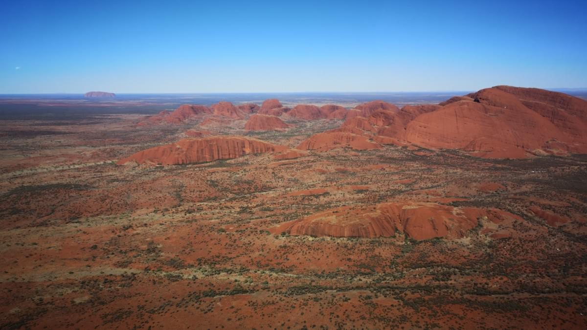 Aerial view of Kata Tjuta with Uluru in the background Aerial view of Kata Tjuta with Uluru in the background