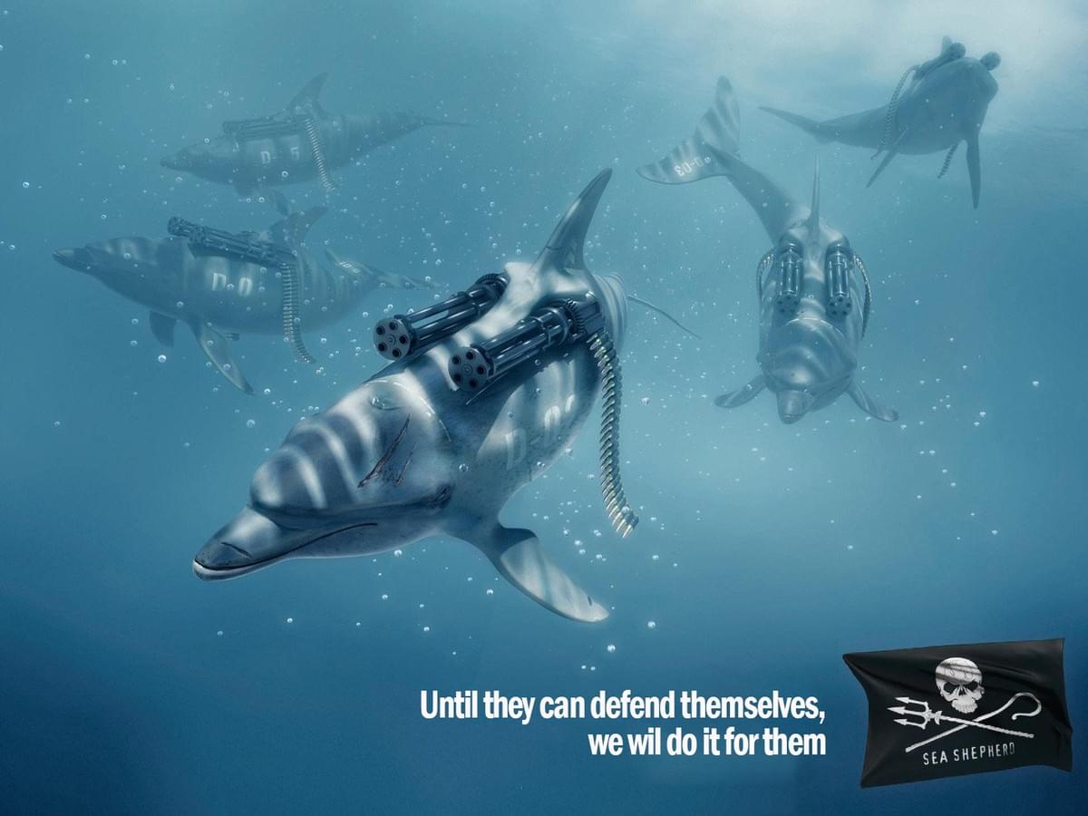 These dolphins appear to be equipped with heavy weaponry to protect themselves from being caught by whalers and the like, almost genetically contoured into their bodies. The slogan declares that until that state of being can happen for dolphins (which it cannot), the people behind the advert would protect them from attack These dolphins appear to be equipped with heavy weaponry to protect themselves from being caught by whalers and the like, almost genetically contoured into their bodies. The slogan declares that until that state of being can happen for dolphins (which it cannot), the people behind the advert would protect them from attack