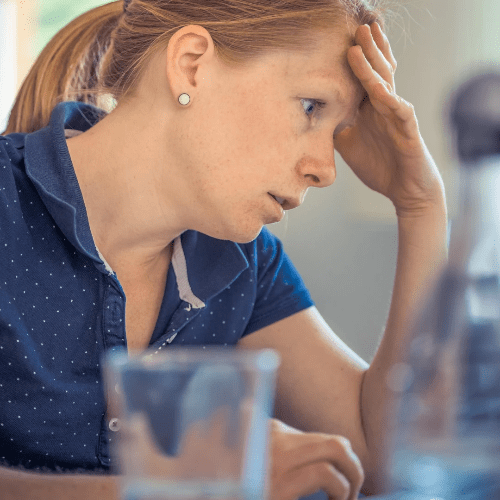 A woman looks at her laptop, worried and stressed. A woman looks at her laptop, worried and stressed.