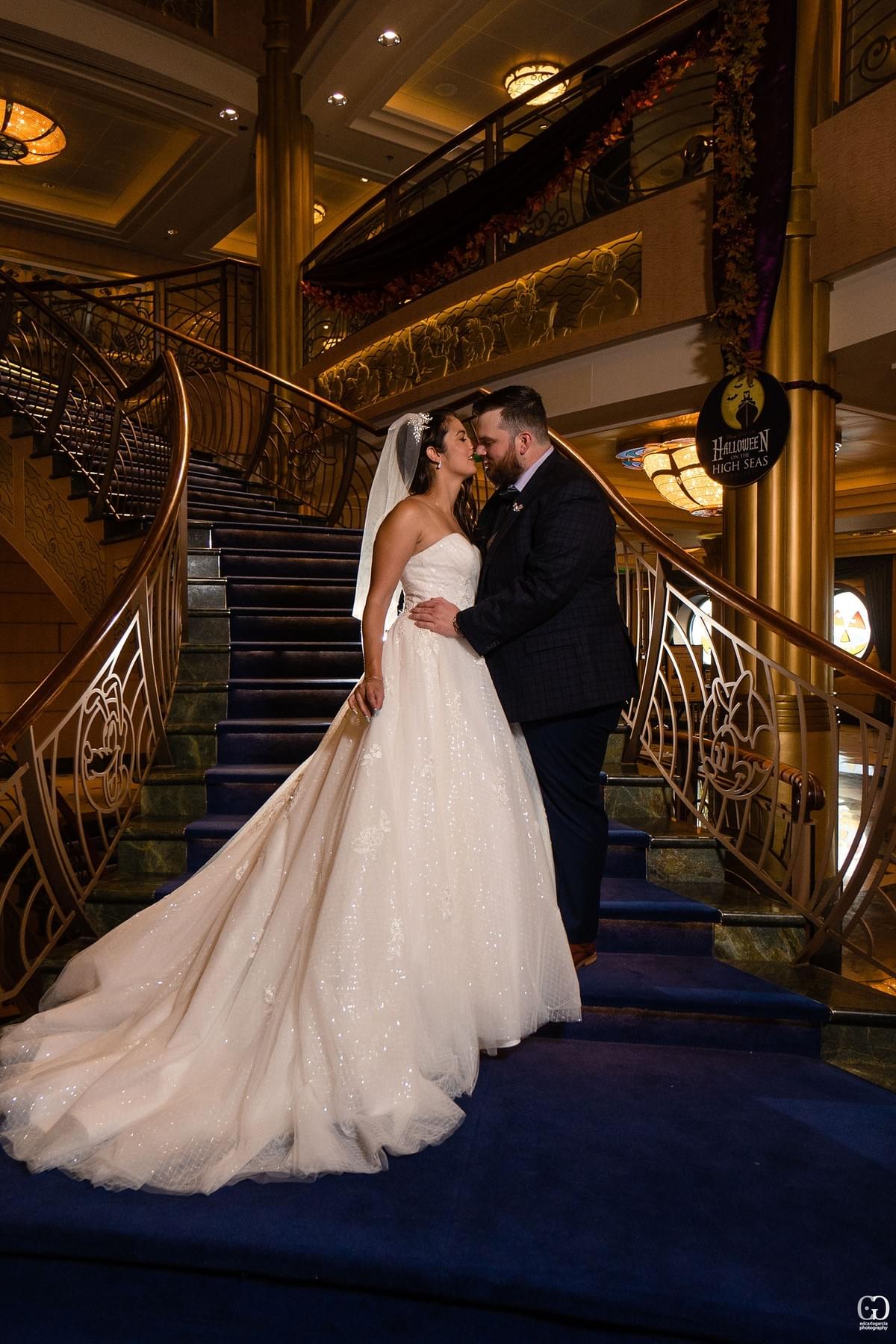 disney cruise line wedding castaway cay bahamas carribean cruise photos of groom and bride almost kissing at the main stairs disney cruise line wedding castaway cay bahamas carribean cruise photos of groom and bride almost kissing at the main stairs