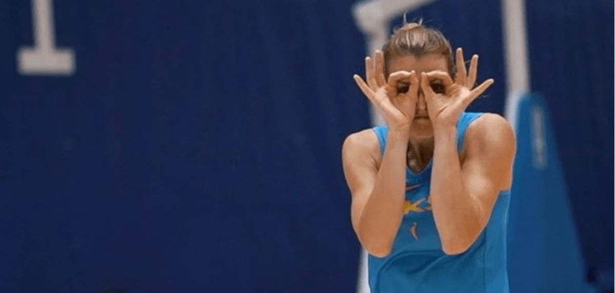 Allie makes threes with her fingers and holds them over her eyes. Allie makes threes with her fingers and holds them over her eyes.