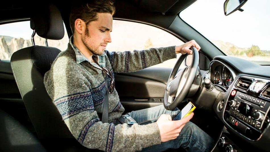 Man texting while driving Man texting while driving