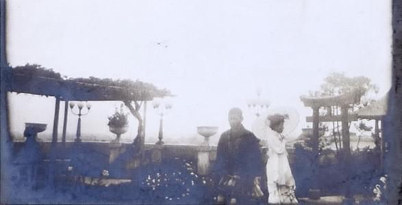 Margaret MacLean with parasol strolling through a park in Japan (perhaps Yokohama) Margaret MacLean with parasol strolling through a park in Japan (perhaps Yokohama)