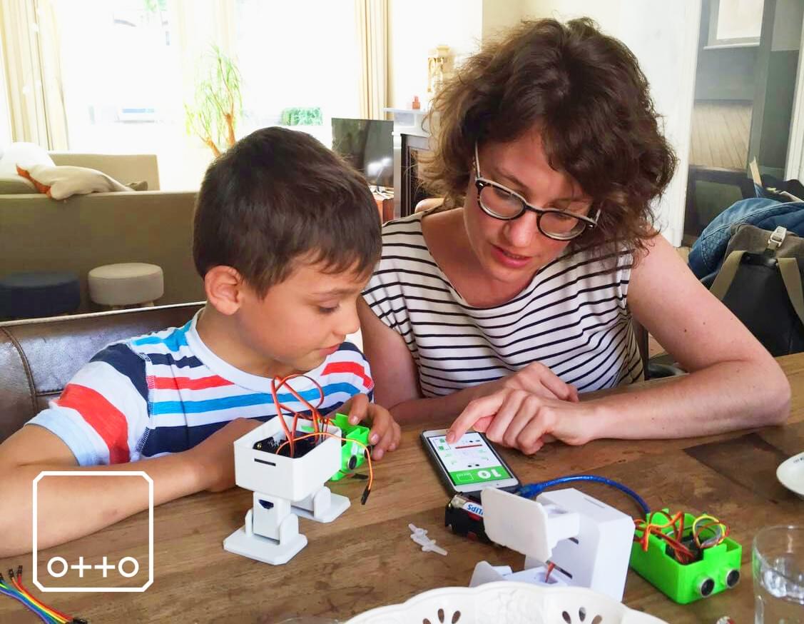 parent helping child assemble a DIY robot kit parent helping child assemble a DIY robot kit