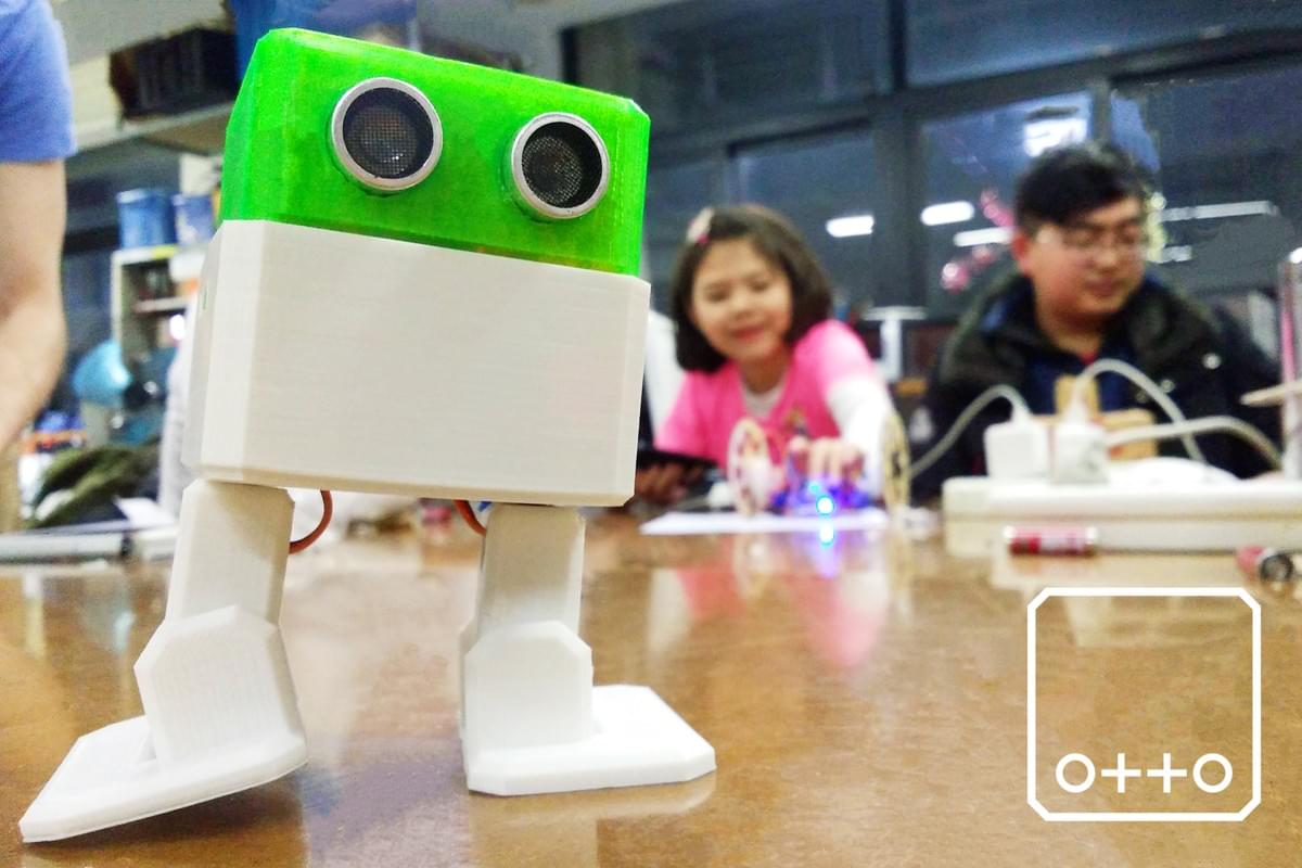 kids playing with a programmable robot in a school setting kids playing with a programmable robot in a school setting