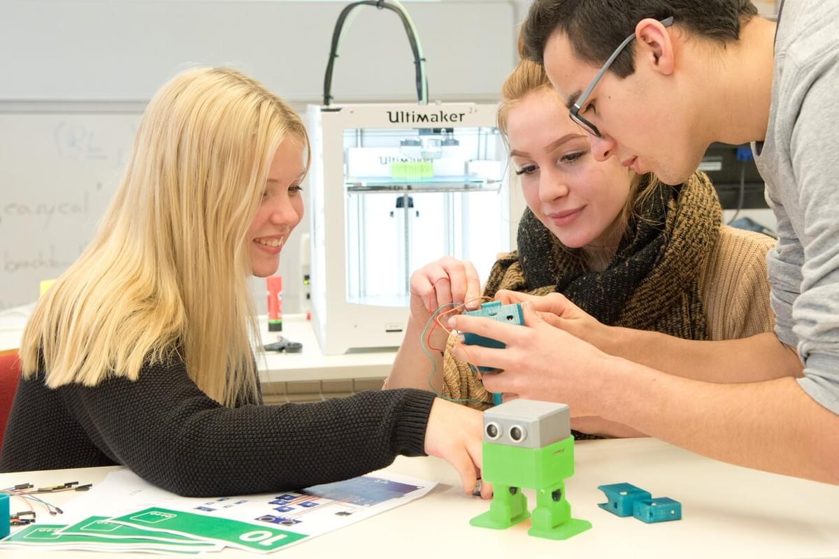 students playing with a diy robot students playing with a diy robot