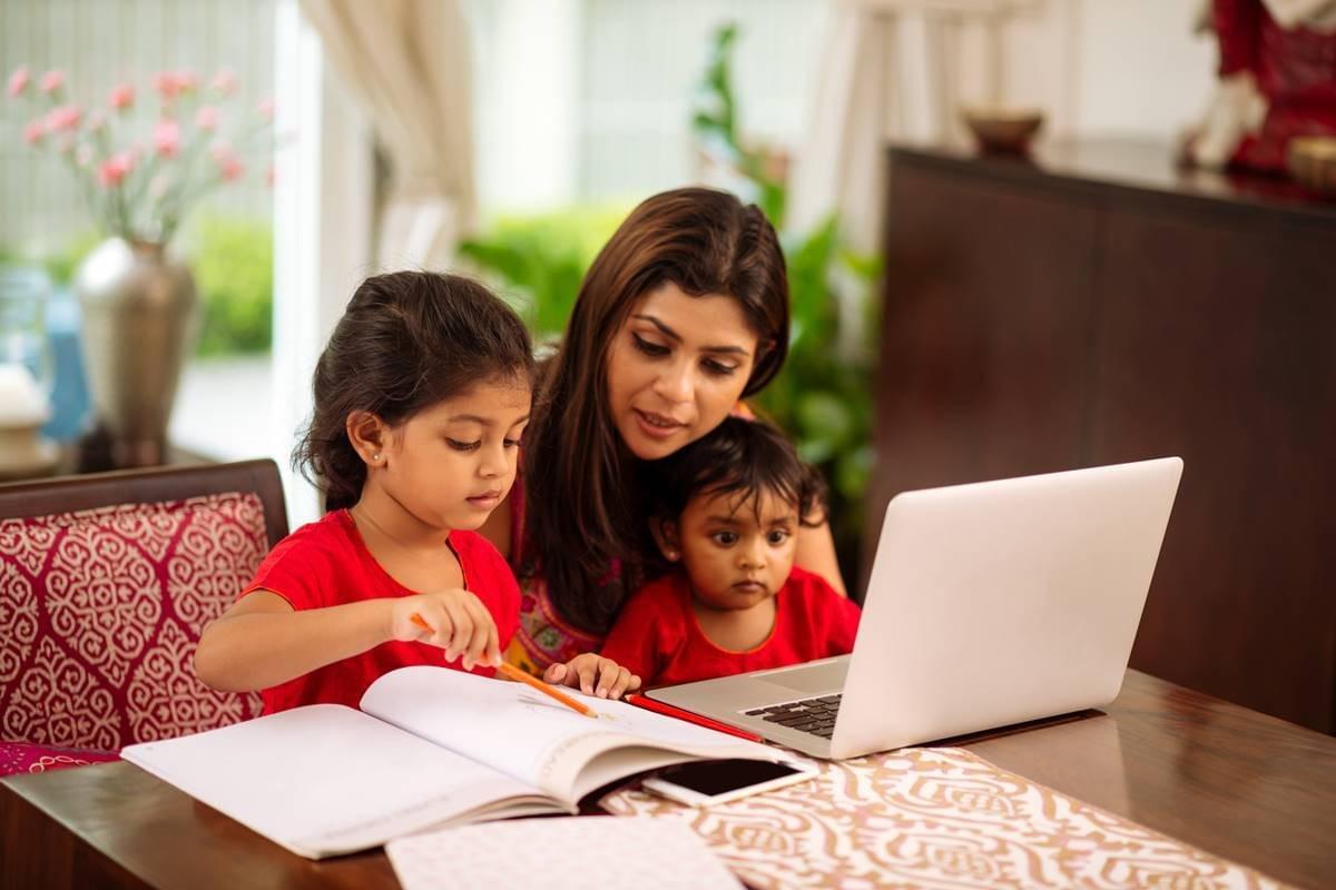 Mother helping her children study. Mother helping her children study.