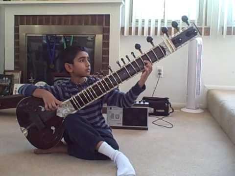 Young boy playing the sitar. Young boy playing the sitar.