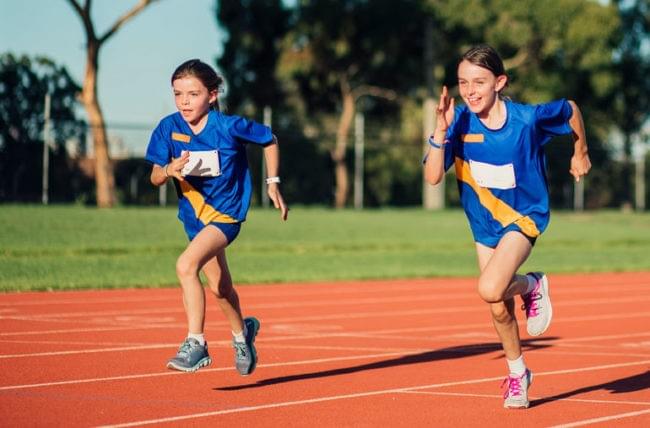 Kids running on the running track. Kids running on the running track.