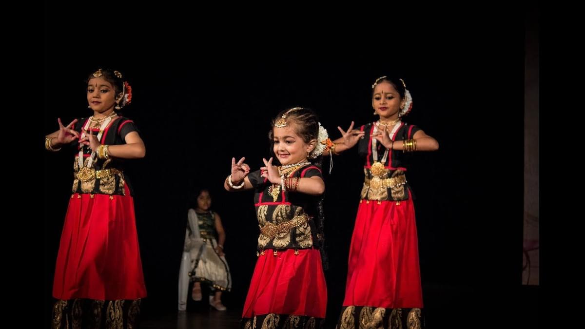 Girls performing bharatanatyam on stage. Girls performing bharatanatyam on stage.