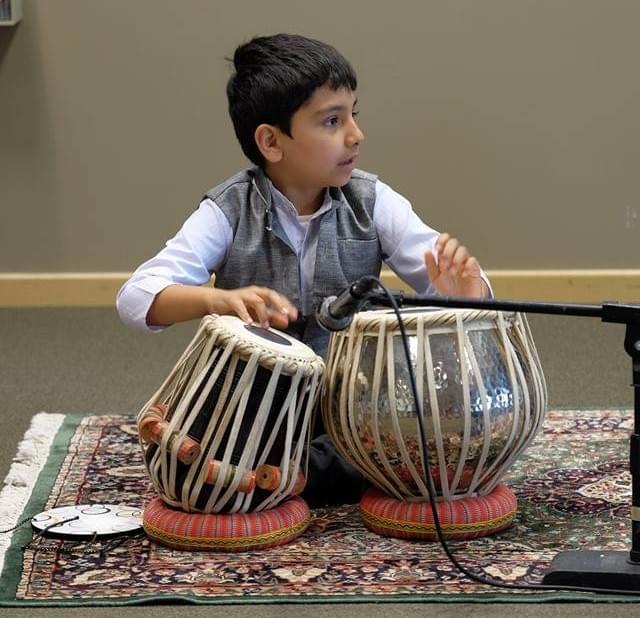 Young kid playing the tabla. Young kid playing the tabla.